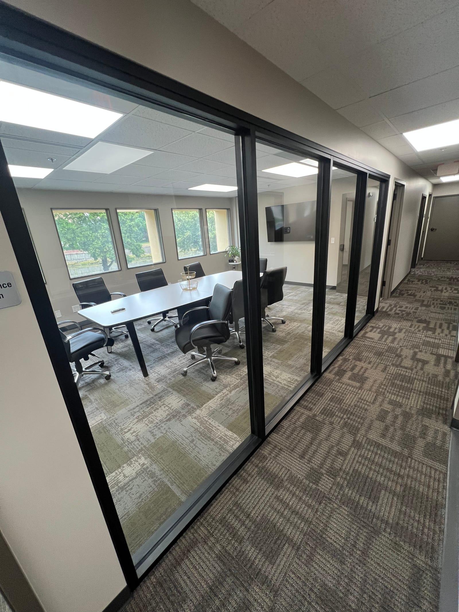 A glass-walled conference room off the corridor at Ironwood Square